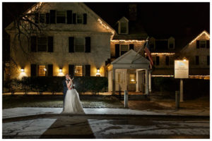 Dramatic bride and groom portrait in front of the Inn on Boltwood