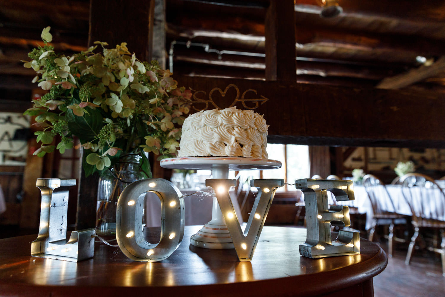 Wedding cake with love sign in foreground