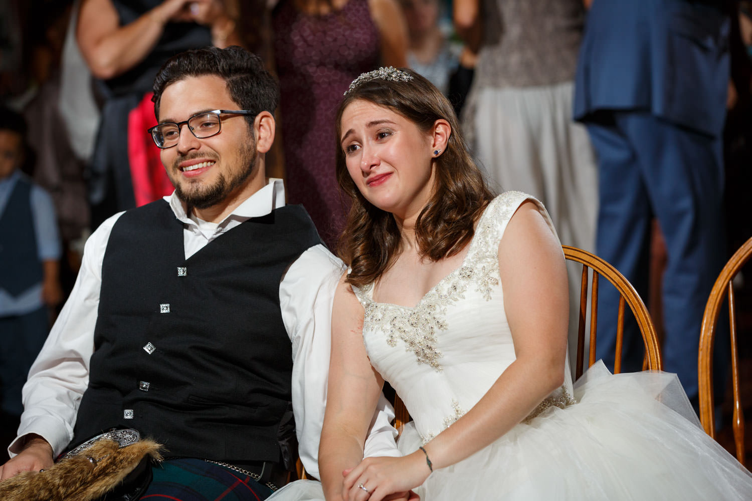 Emotional Bride and Groom viewing their same day slideshow