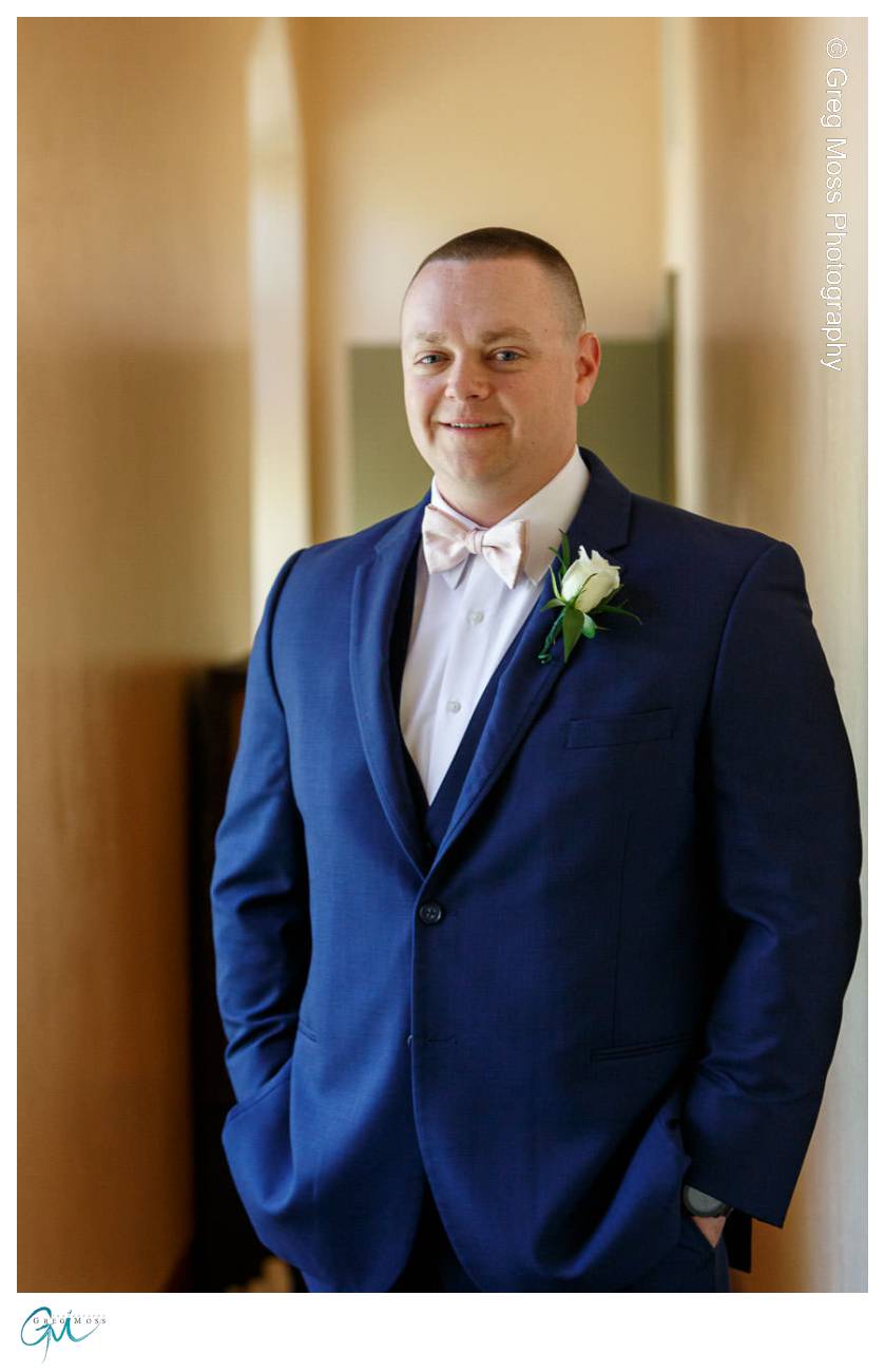 Groom Portrait in blue suit and pink bow tie at church