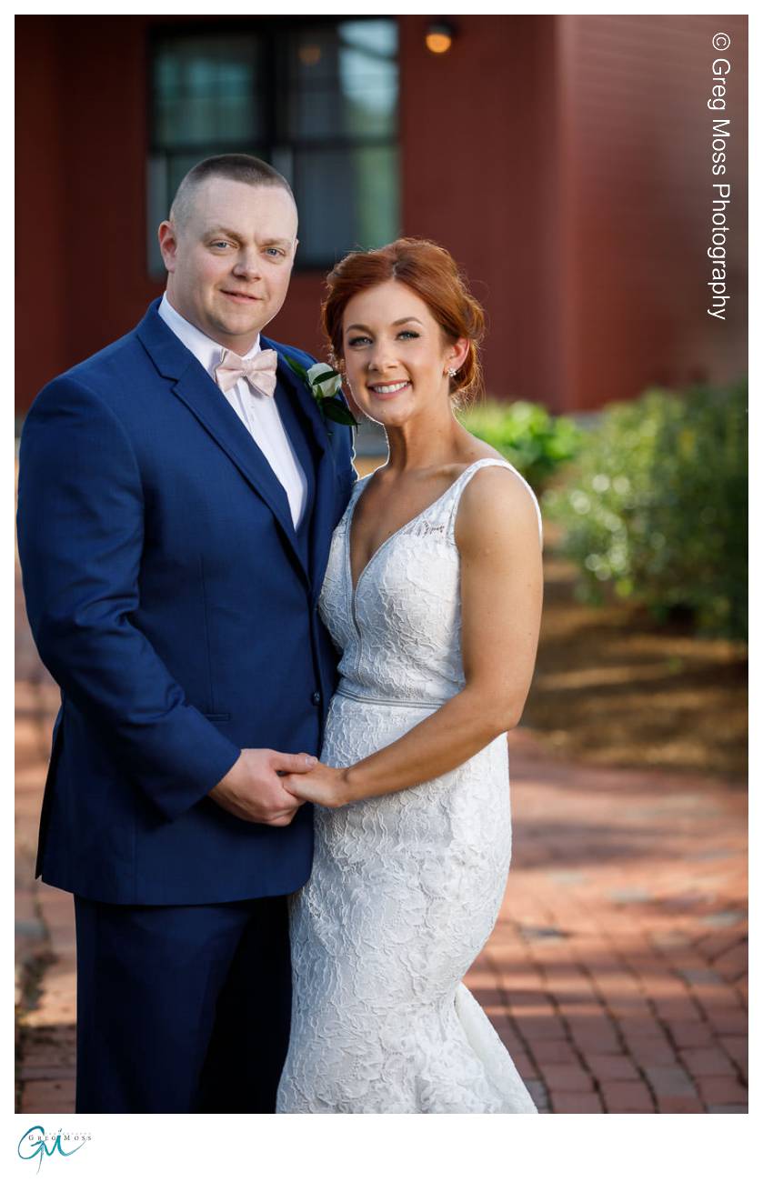 Bride and groom in front of barn