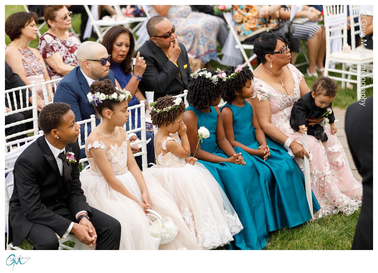 Family sitting in chairs during ceremony