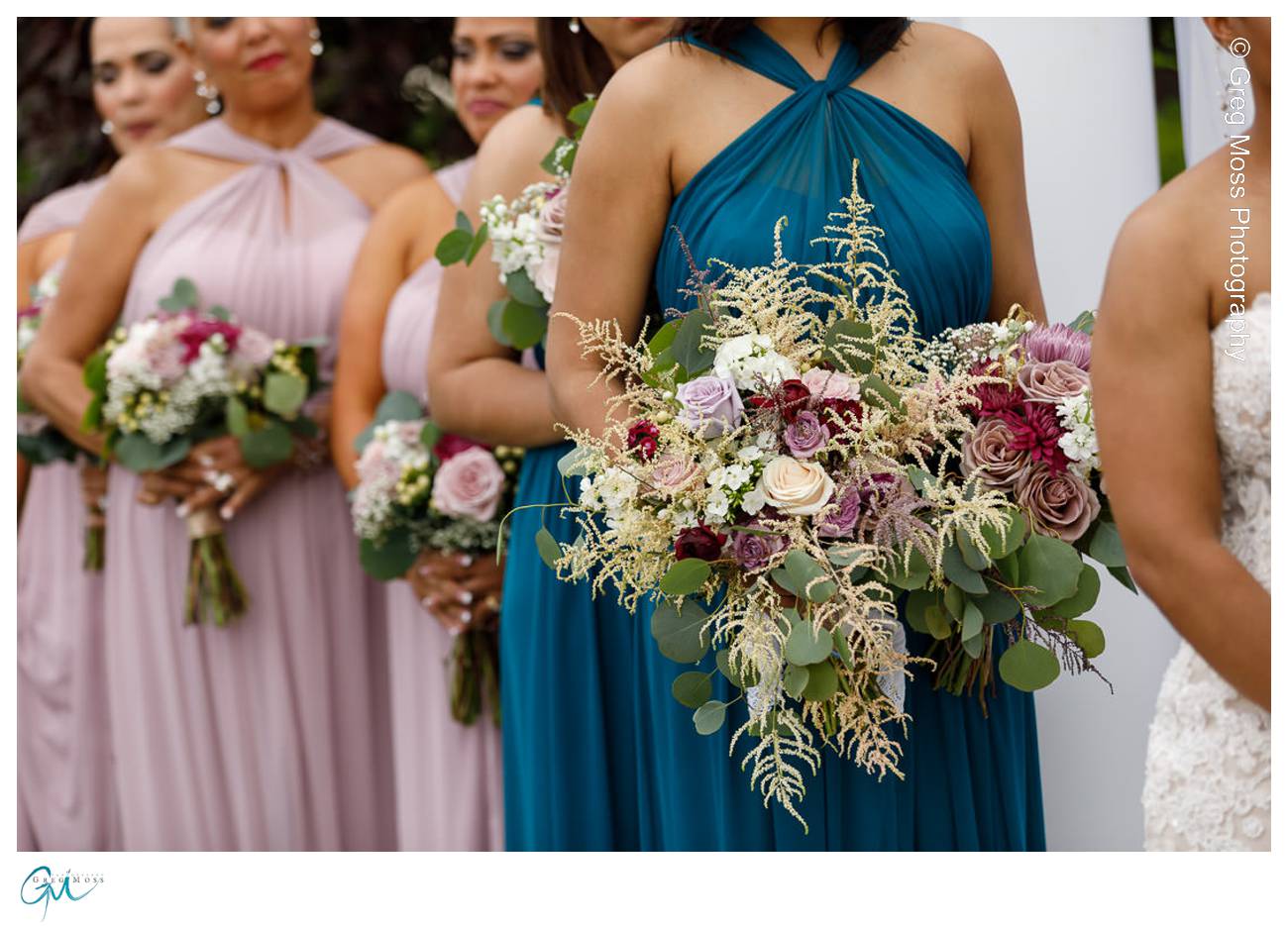 Maid of honor holding brides bouquet during ceremony