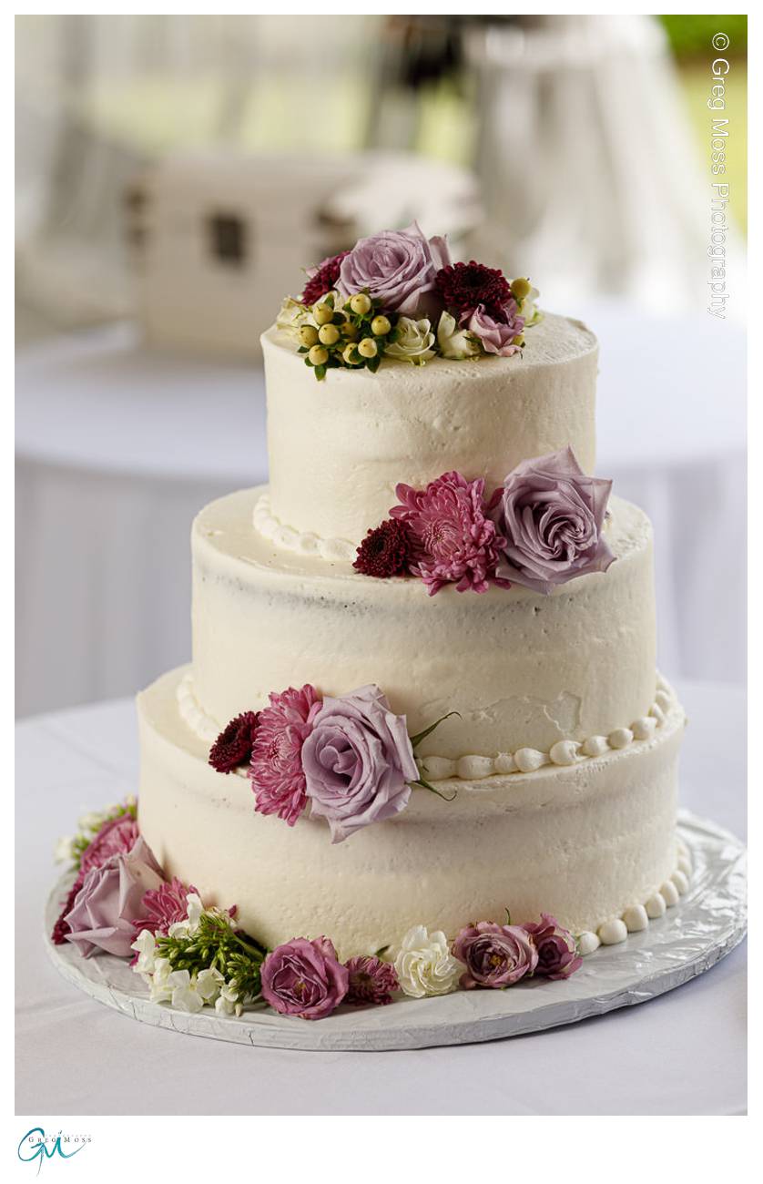 White wedding cake with purple flowers