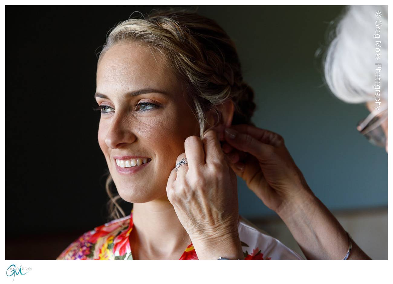 Bride's mother helping with brides earrings