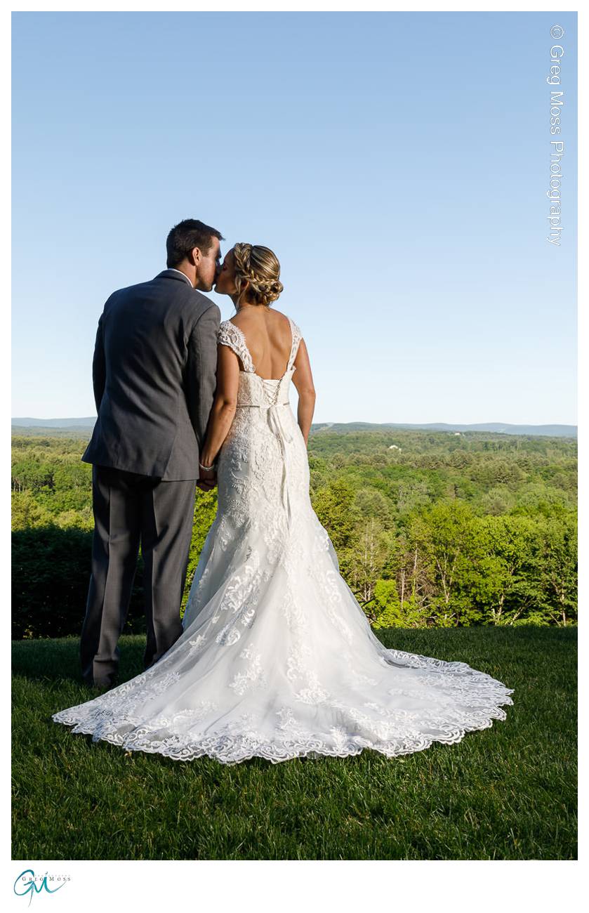 Bride and Groom kiss while overlooking stunning background