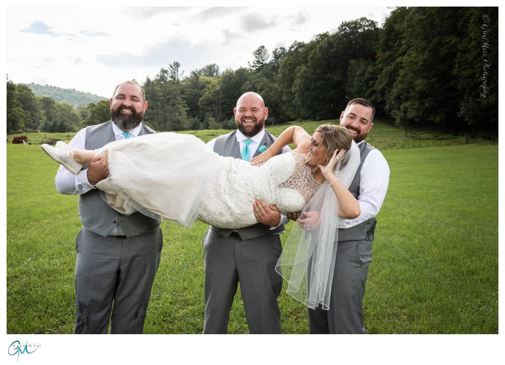 Groom and groomsmen picking up bride.