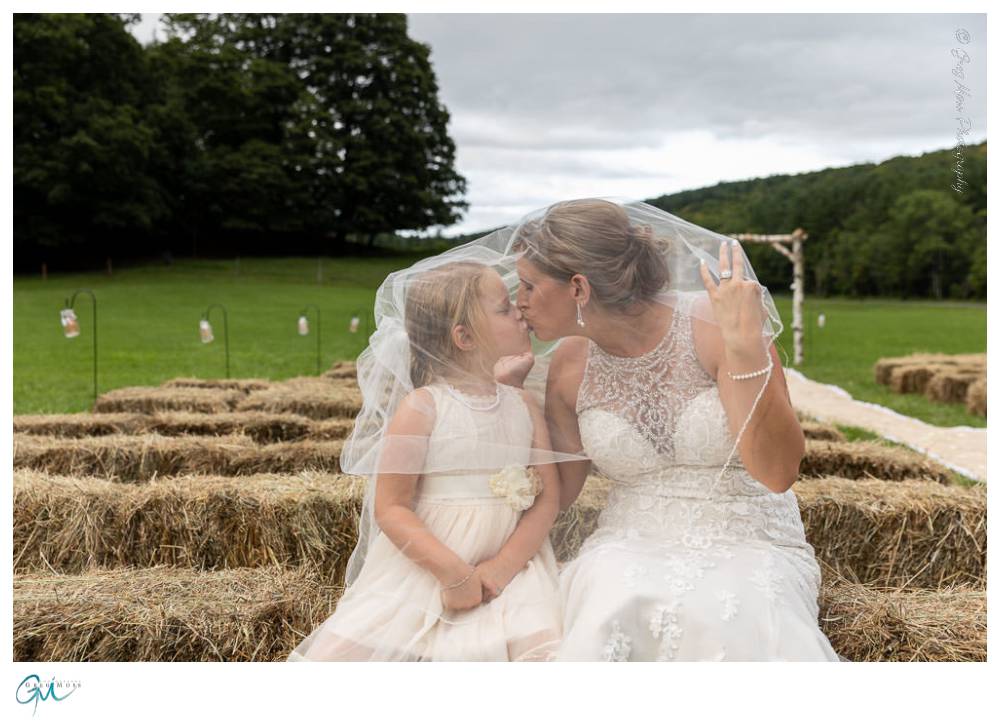 Bride and flower girl with veil over both