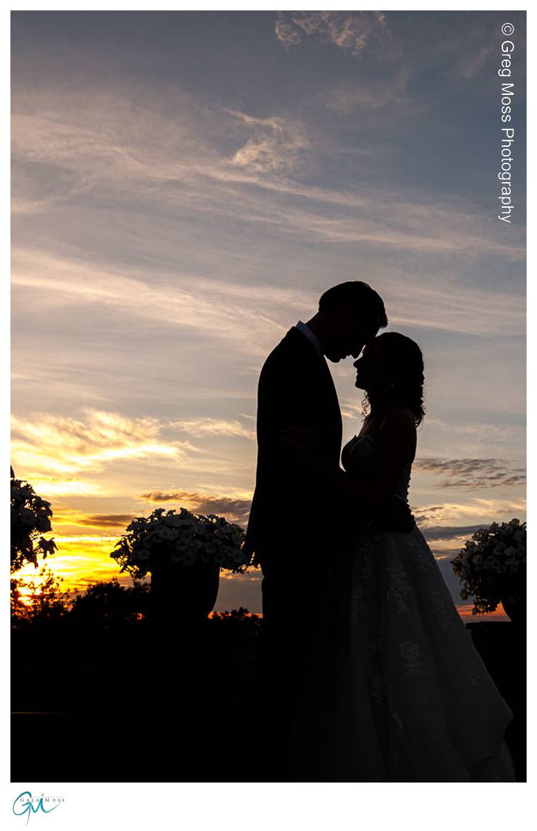 silhouette of bride and groom at sunset