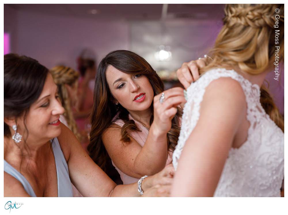 Log Cabin Wedding Photographer-5 Mother of the Bride and Maid of honor helping button up the dress