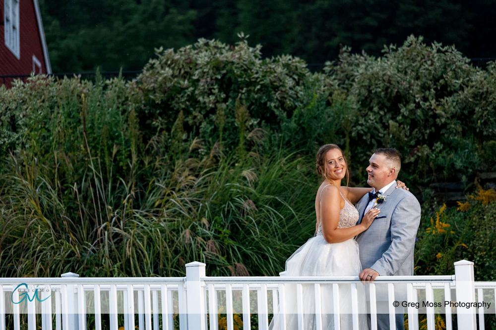 Bride and groom on small bridge.