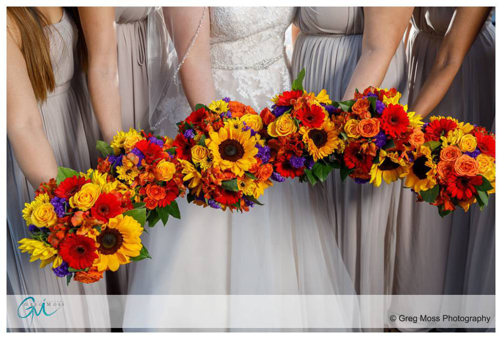 Bride and bridesmaids holding flowers together