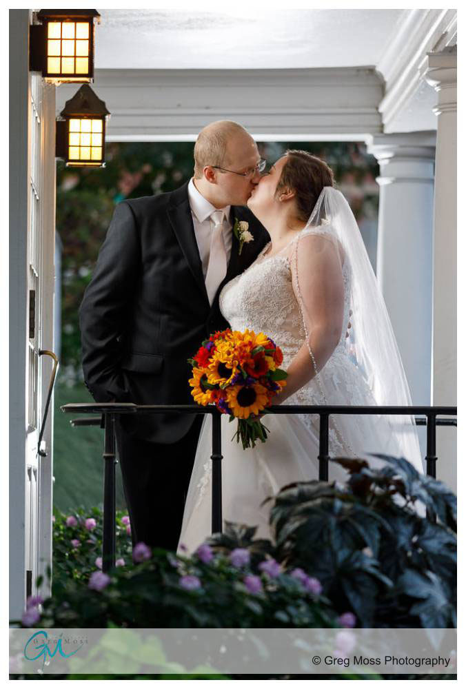 Bride and Groom kissing by side door of the inn on boltwood.