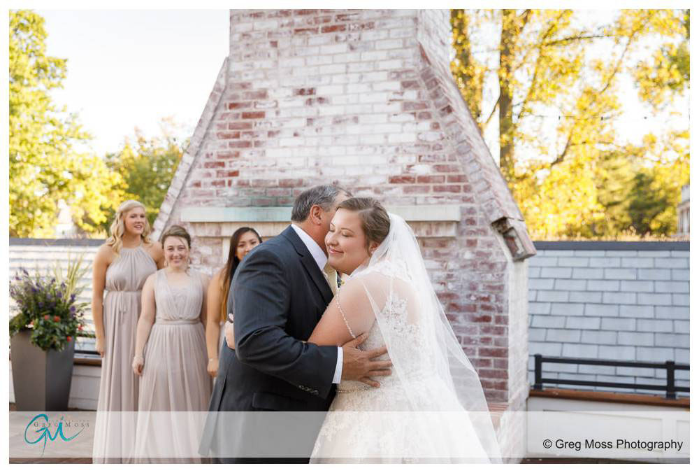 Father seeing bride first time with wedding dress on and hugging
