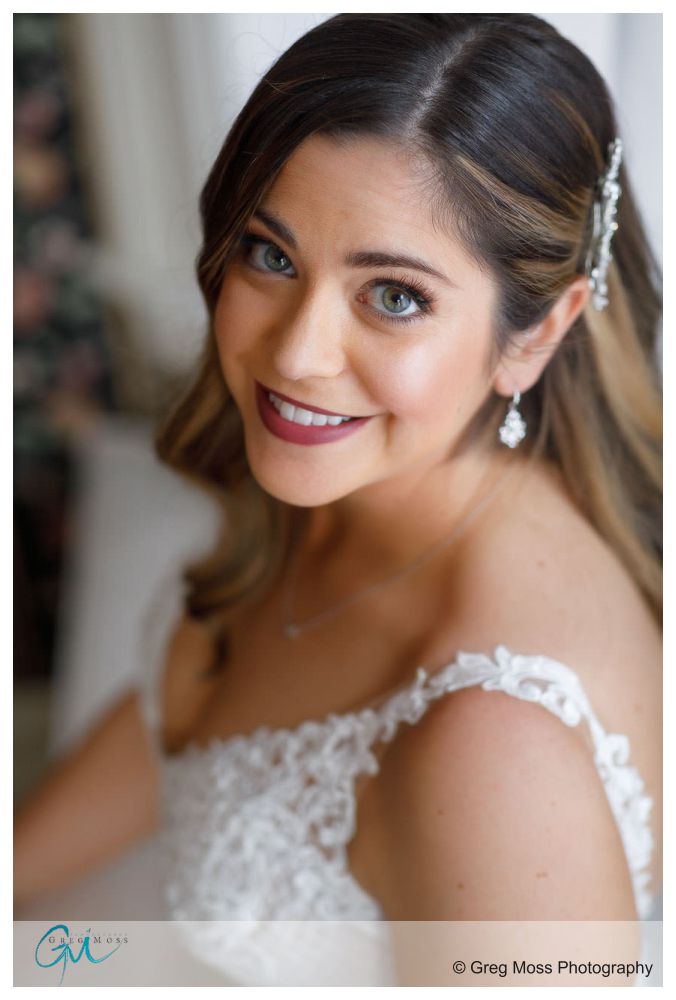 Beautiful bridal portrait next to large bay window.