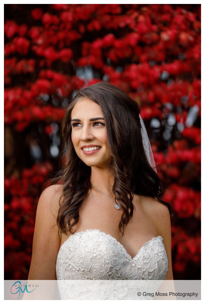 Portrait of bride outside with fire bush in the background
