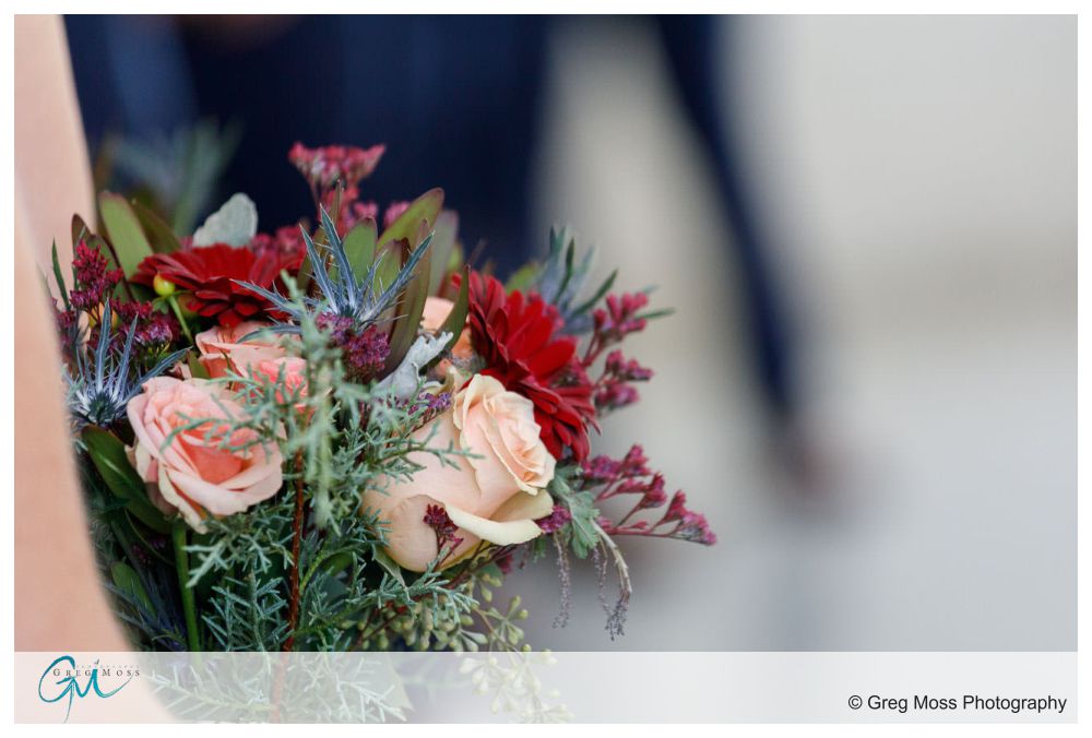 Bridal bouquet being held by maid of honor during ceremony