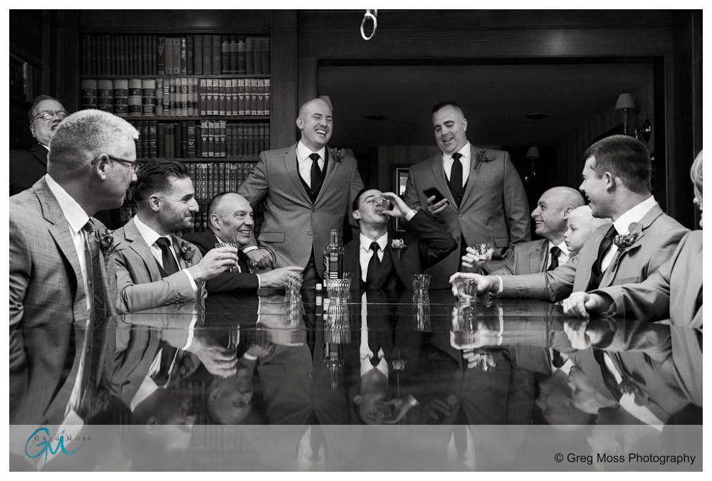 Publick House Wedding-8 Black and White photo of Groom, Fathers, groomsmen in library at publick house toasting with whiskey
