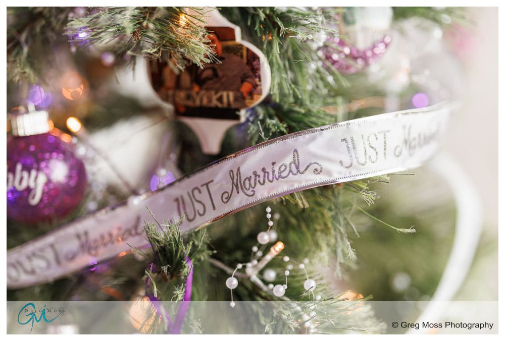 Inn on Boltwood Fall wedding-15 Close-up of a Christmas tree decorated with an "Inn on Boltwood Fall Wedding" ribbon, purple ornaments, and white lights, conveying a festive and celebratory mood.