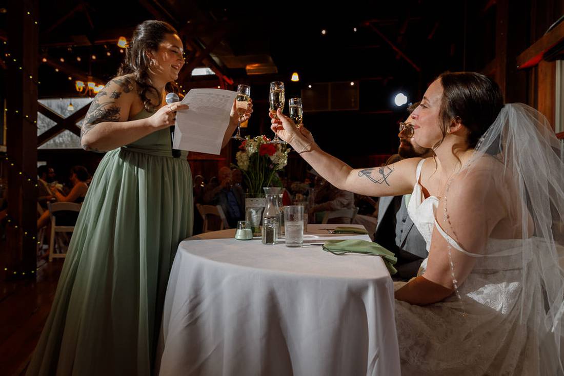 Red Barn Wedding Photography-20 Maid of honor toasting the bride and groom