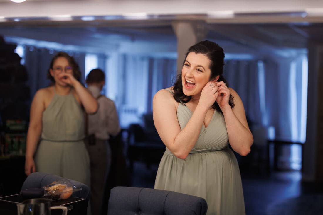 Red Barn Wedding Photography-8 Bridesmaid putting on earrings