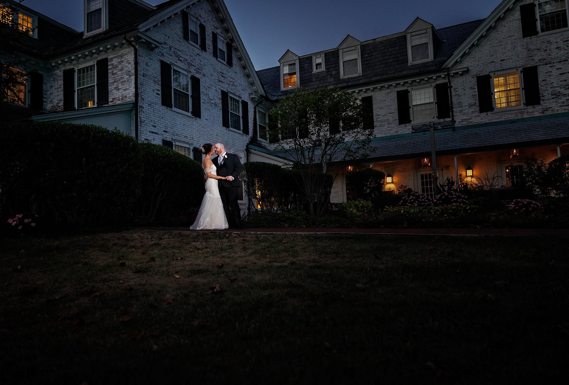 Bride and groom wedding photo in front of the Inn on Boltwood